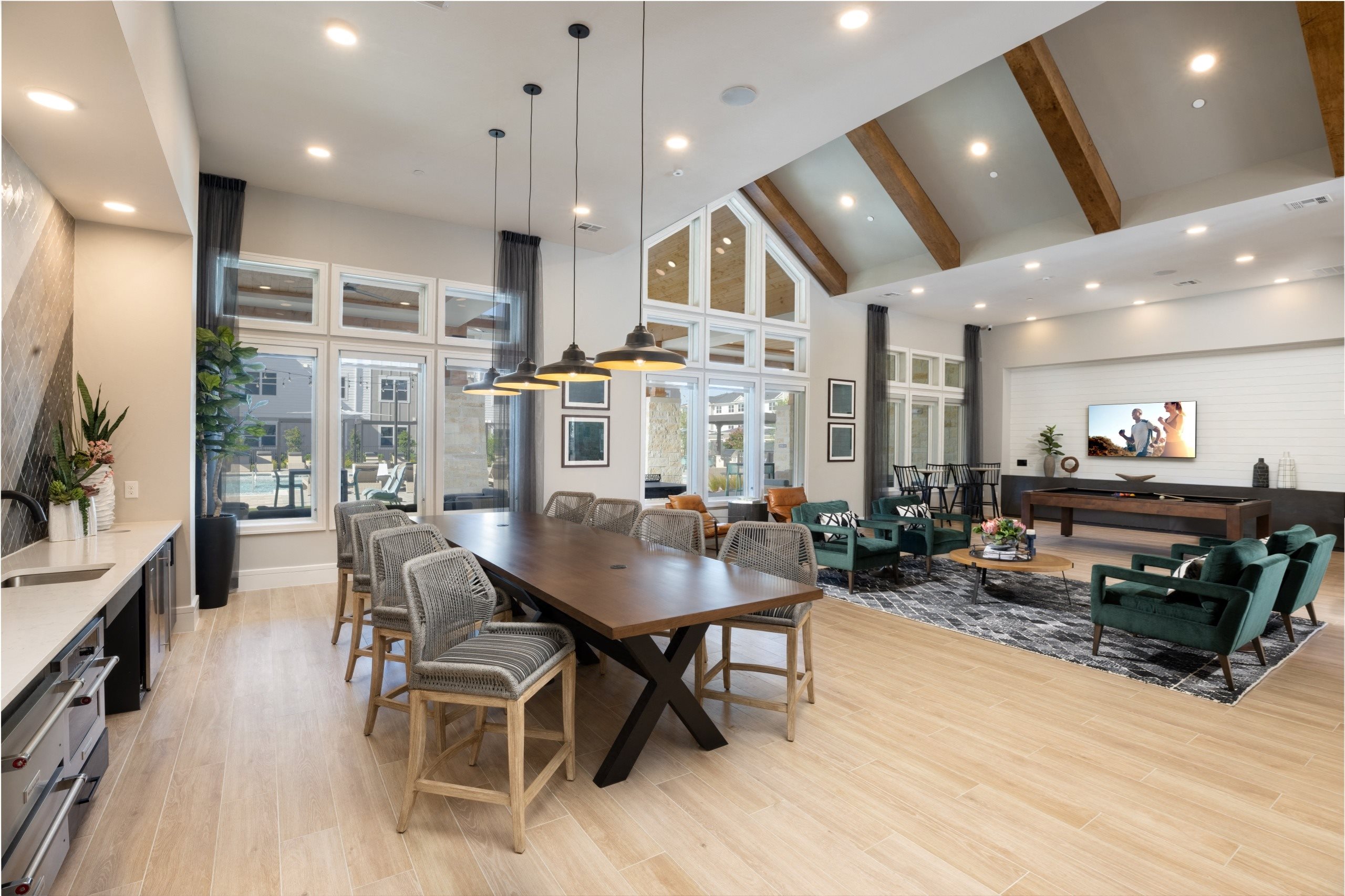 a large dining room with a wooden table and chairs